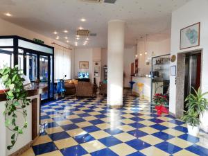 eine Lobby mit blauem und weißem kariertem Boden in der Unterkunft Blue Moon Hotel in Pantelleria