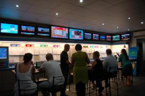a group of people sitting in a betting room at Slipway Hotel Motel in Ballina