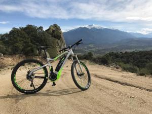 a bike parked on a dirt road with mountains in the background at Casa ilicia in Eus