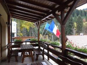 a flag on a patio with a table and benches at Casa Anca Boutique Hotel in Braşov