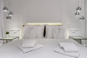 a white bed with two white pillows on it at Room 25 Belgrade in Belgrade