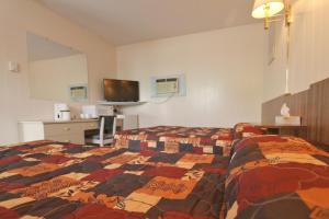 Postel nebo postele na pokoji v ubytování Sunset Motel