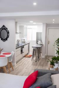 a kitchen and living room with a couch and a table at Apartamento Valtour Valladolid in Valladolid