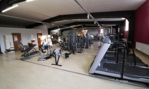 a gym with treadmills and elliptical machines at Hotel Adria in Rumia