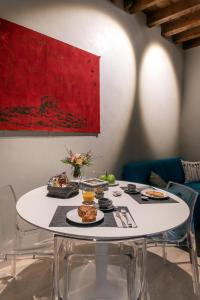 a white table with plates of food on it at Borgo San Leonardo in Bergamo