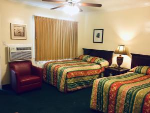 a hotel room with two beds and a window at Los Feliz Hotel in Glendale