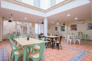 a restaurant with tables and chairs in a room at Hostel SEA&DREAMS Calpe in Calpe