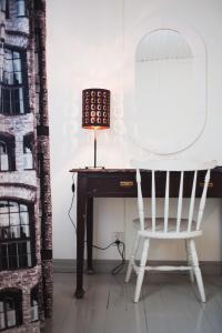 a white chair sitting next to a desk with a mirror at Villa Korkatti in Haapavesi
