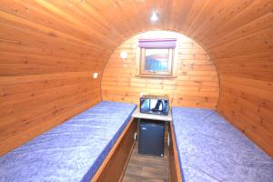 a bedroom with a bunk bed and a window at Glamping Pods in Kinlochleven