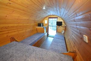 a small room with a bed in a wooden cabin at Blackwater Glamping Pods in Kinlochleven