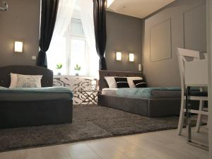 a living room with two beds and a couch at Sweet Dream in Zielona Góra