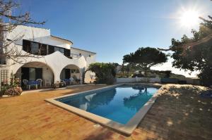 a swimming pool in front of a house at VIVENDA JOHANNA in Lagos