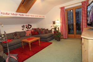 sala de estar con sofá y mesa en Ferienwohnungen Wurzer Toni, en Grainau