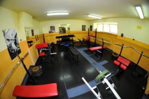 an empty room with red chairs and a table at Ośrodek Szpulki in Zakopane