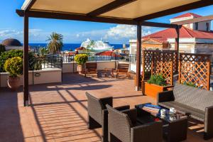 a balcony with a view of a cruise ship at In Camera Art Boutique Hotel in Rhodes Town