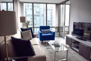 a living room with a couch and a tv at Vancouver Extended Stay in Vancouver