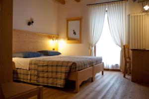 En eller flere senge i et værelse på Agritur Renetta