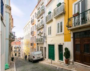 a white van parked in a street with buildings at Ultra Chic Santa Catarina in Lisbon