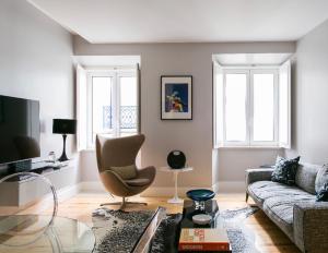 a living room with a couch and a chair at Ultra Chic Santa Catarina in Lisbon