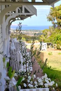 a garden with a white fence and flowers at Watson Park in Yankalilla