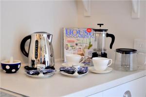 a kitchen counter with a coffee pot and cups on it at Watson Park in Yankalilla