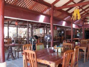 a wooden table and chairs in a restaurant at SiBoya Bungalows in Siboya