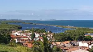 a view of a town and a body of water at Azul Kitnets in Santa Cruz Cabrália