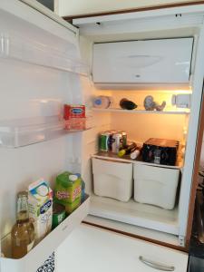 a refrigerator door is open with food and drinks at Iglo Bungalow 17 in Chaam