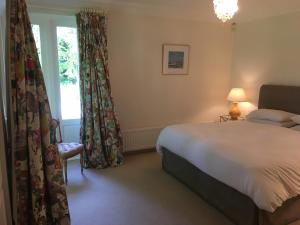 a bedroom with a bed and a window at Gweebarra in Holywood