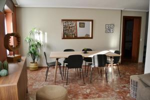 a dining room with a table and chairs at Tres Puentes Anguiano Apartamentos y Hostal in Anguiano