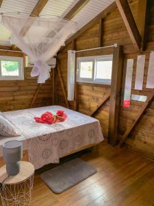a room with a table in a wooden cabin at Les Bungalows de la Sucrerie in Le François