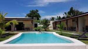 a swimming pool in the yard of a house at Positano Alona Beach Panglao in Panglao