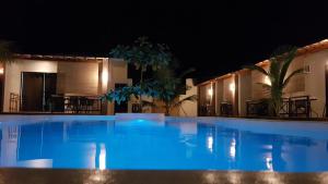 a large blue swimming pool at night at Positano Alona Beach Panglao in Panglao