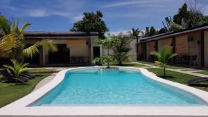 a swimming pool in the yard of a house at Positano Alona Beach Panglao in Panglao