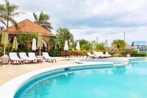 a swimming pool with chairs and umbrellas in a resort at Suite San Juan 133 Gran Pacifica Resort in San Diego