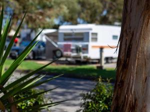 an rv is parked in front of a house at Windsor Gardens Caravan Park in Adelaide