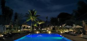 a swimming pool at night with lights at Luang Prabang chanon hotel in Luang Prabang