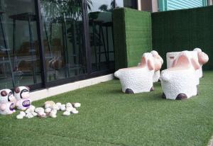 a group of stuffed animals sitting on the grass at Lew Residence in Phayao