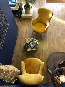 a living room with two chairs and a table at Hotelo Lyon Charité in Lyon