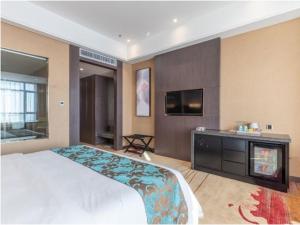 Postel nebo postele na pokoji v ubytování Shenyang Huaqiang Novlion Hotel
