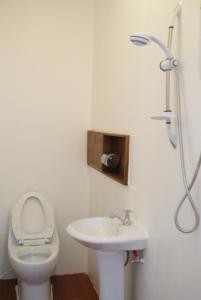 a bathroom with a toilet and a sink at Tara Raft in Kanchanaburi