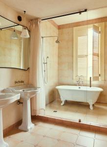 a bathroom with a tub and a sink at Hotel Peter and Paul in New Orleans