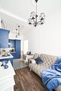 a living room with a couch and blue cabinets at LUX APARTAMENT на Левицького in Lviv