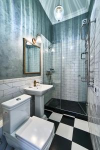 a bathroom with a toilet and a sink and a shower at LUX APARTAMENT на Левицького in Lviv