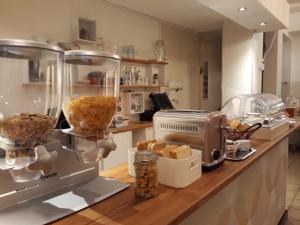 a kitchen counter with a mixer and some food at Hostel 45 in Bonn
