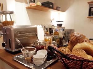 a counter with a tray of bread and a toaster at Hostel 45 in Bonn
