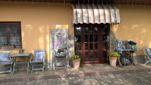 a building with a table and chairs and a door at BB Boutique Hotel in Újlengyel