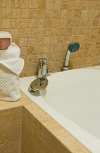 w łazience znajduje się umywalka z kranem i ręcznik. w obiekcie Domeniul Dornei w mieście Vatra Dornei