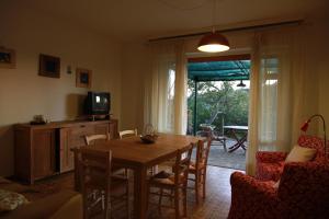a living room with a wooden table and chairs at Villa Giulia al mare in Castiglione della Pescaia