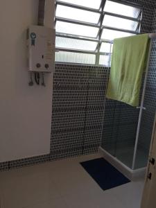 a bathroom with a shower with a window and a towel at Great Moments Copacabana in Rio de Janeiro